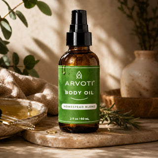 All-natural homestead body oil featuring organic jojoba oil, cold-pressed meadowfoam seed oil, sweet almond, and organic rosehip oil. This nourishing, small-batch formula is presented in an amber glass bottle.